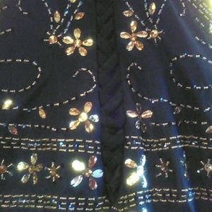 Long formal mermaid gown with hand sewn beading.